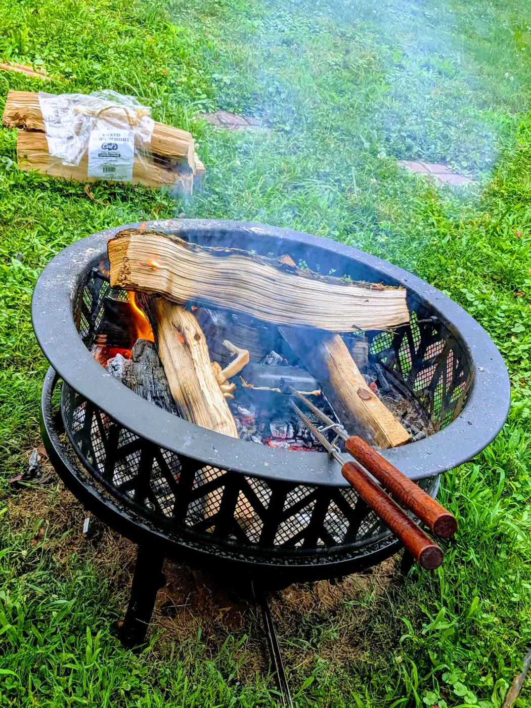 A backyard fire pit at dusk